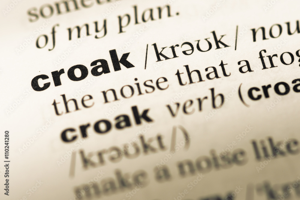Close up of old English dictionary page with word croak Close up of old English dictionary page with word croak