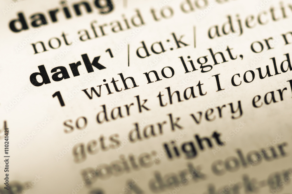 Close up of old English dictionary page with word dark Close up of old English dictionary page with word dark