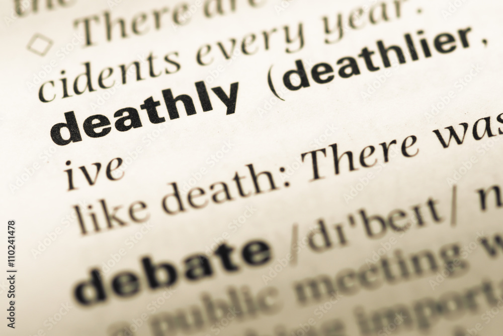 Close up of old English dictionary page with word deathly Close up of old English dictionary page with word deathly