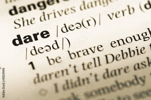 Photos Close up of old English dictionary page with word dare