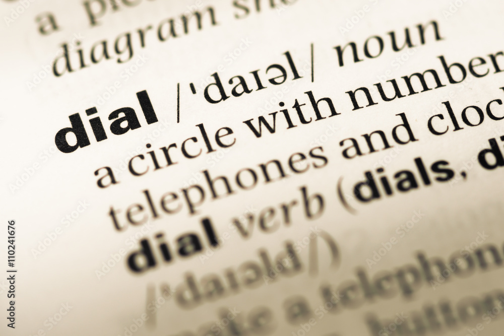 Close up of old English dictionary page with word dial Close up of old English dictionary page with word dial