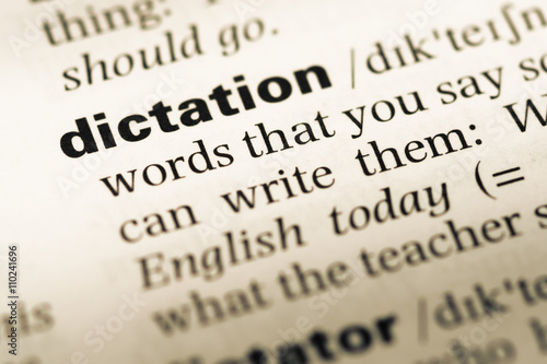 Фотография Close up of old English dictionary page with word dictation