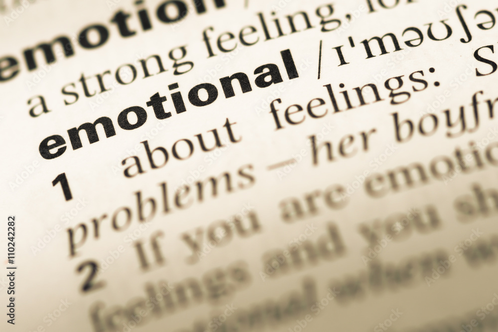 Close up of old English dictionary page with word emotional Close up of old English dictionary page with word emotional