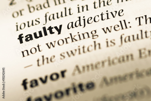 Papier peint Close up of old English dictionary page with word faulty