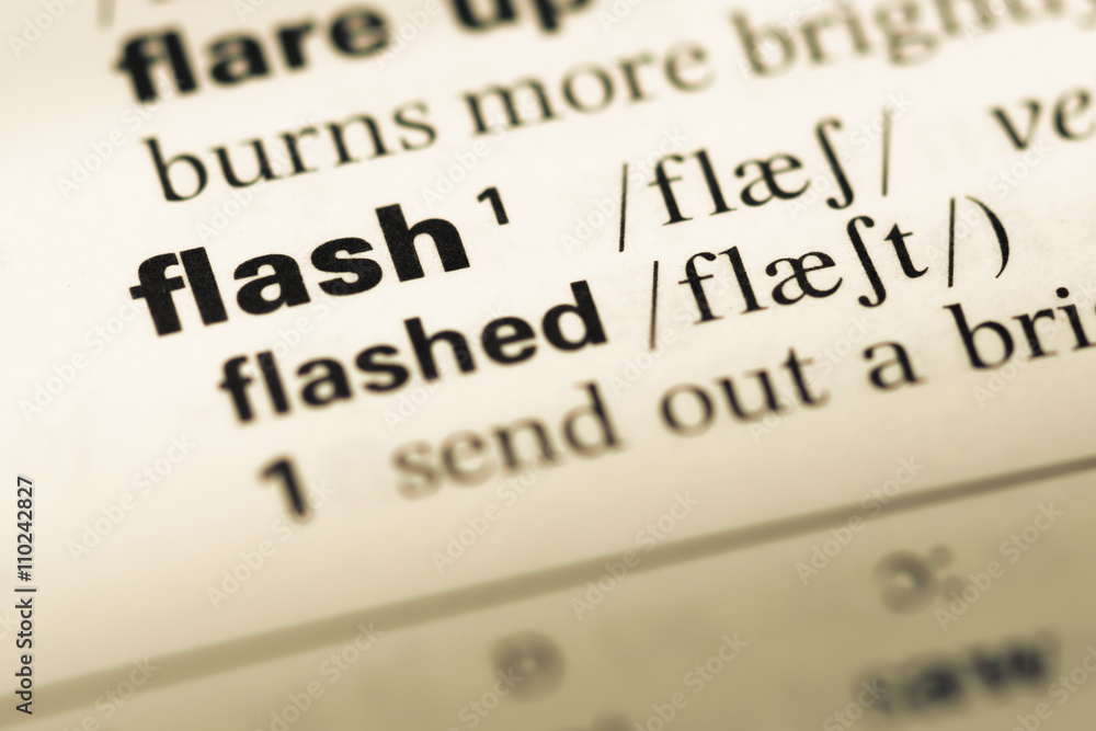 Close up of old English dictionary page with word flash Close up of old English dictionary page with word flash