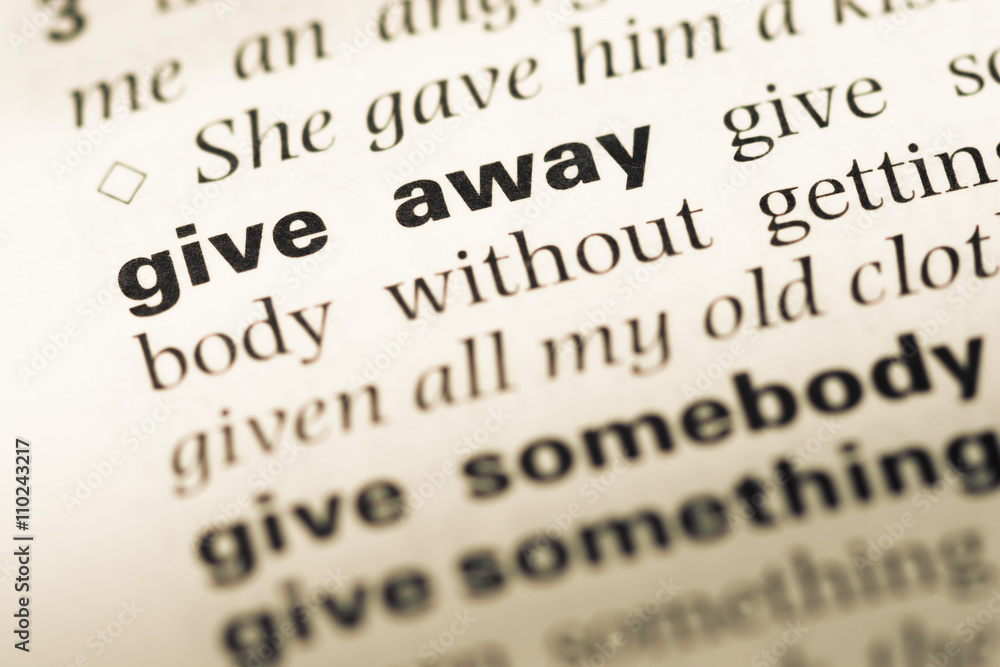 Obraz premium Close up of old English dictionary page with word give away