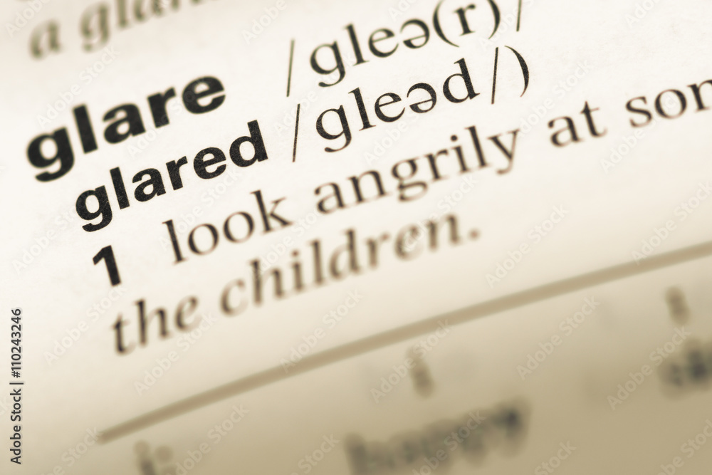 Close up of old English dictionary page with word glared Close up of old English dictionary page with word glared