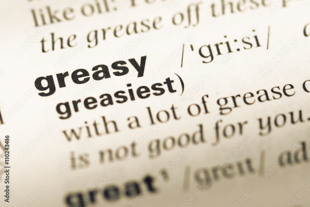 Close up of old English dictionary page with word greasy Close up of old English dictionary page with word greasy