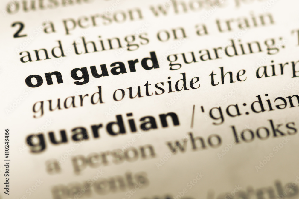 Close up of old English dictionary page with word on guard Close up of old English dictionary page with word on guard