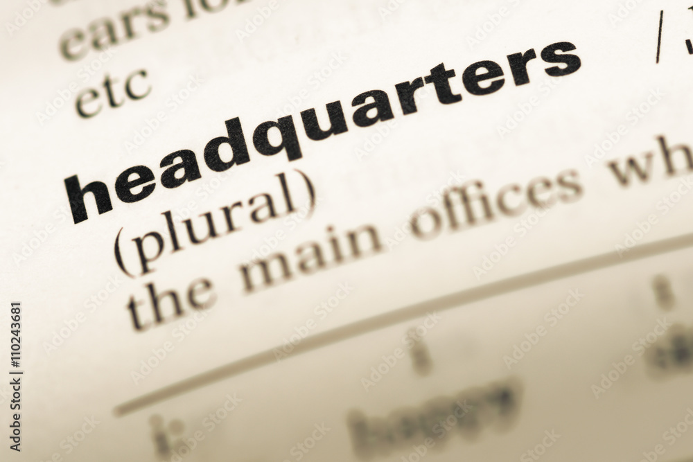 Close up of old English dictionary page with word headquarters Close up of old English dictionary page with word headquarters