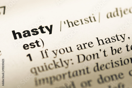 Close up of old English dictionary page with word hasty