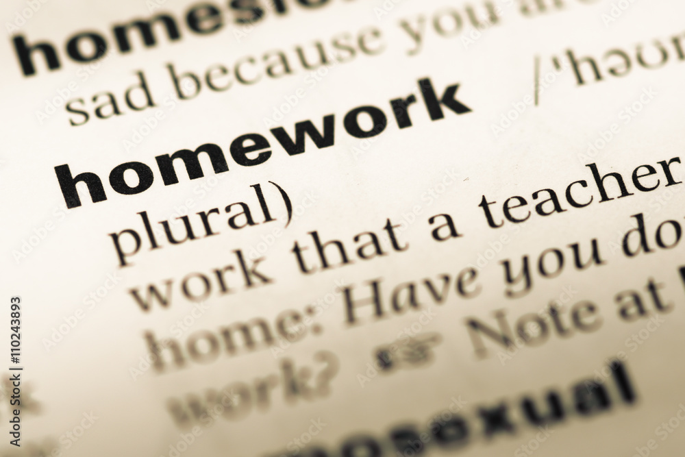 Obraz premium Close up of old English dictionary page with word homework