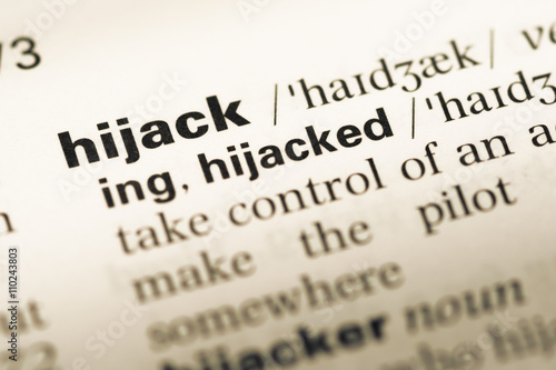 Close up of old English dictionary page with word hijack