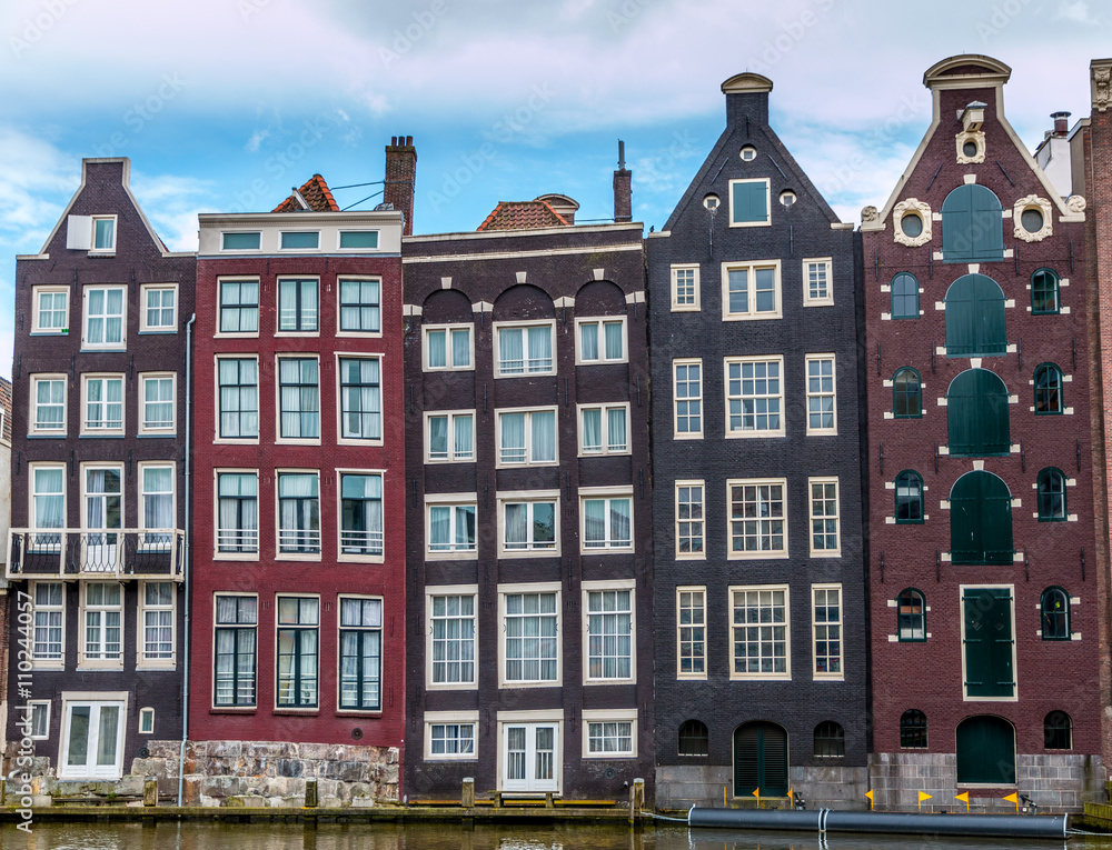 Moody clouds hang over houses built in the 17th century along the canals of Amsterdam.
