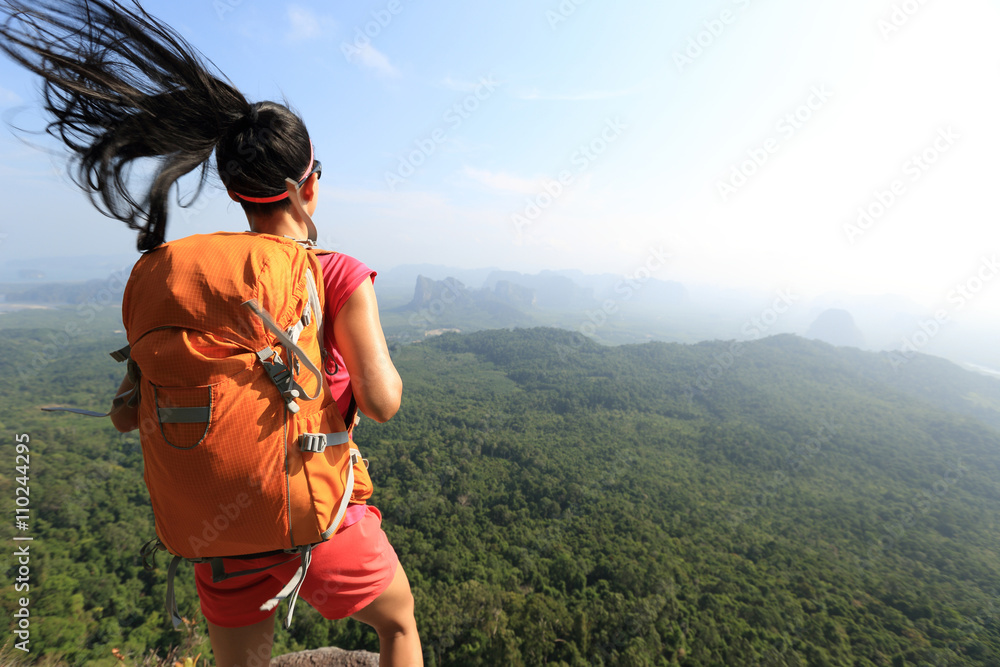 Naklejka premium successful woman hiker enjoy the view on mountain top