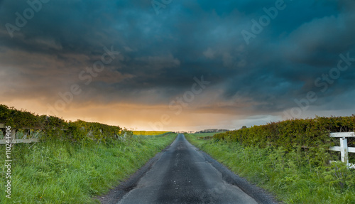 Spring Shower Clouds Above Empty British Countryside Road
