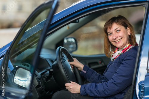 Happy young woman sitting in new car. © De Visu