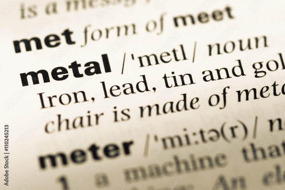 Close up of old English dictionary page with word metal Close up of old English dictionary page with word metal