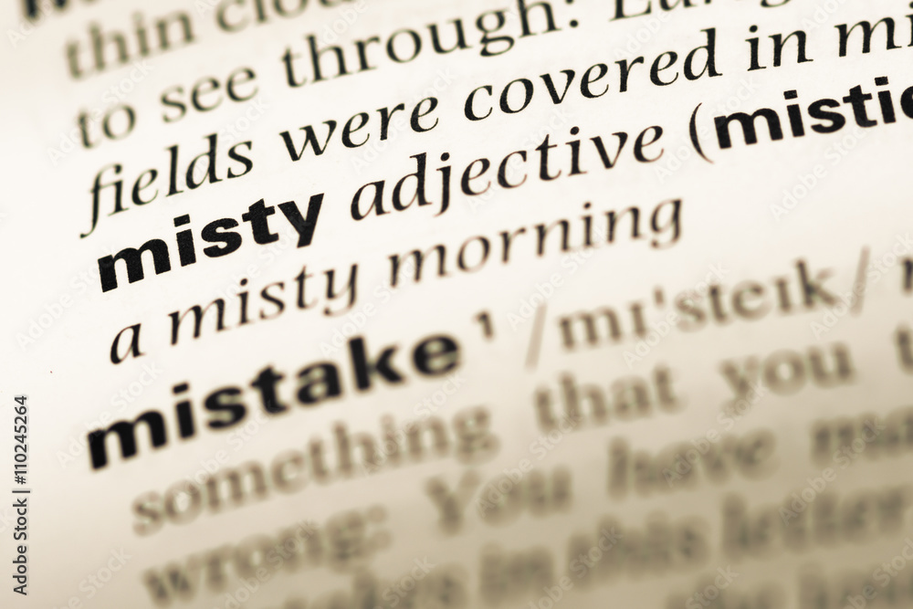 Close up of old English dictionary page with word misty Close up of old English dictionary page with word misty