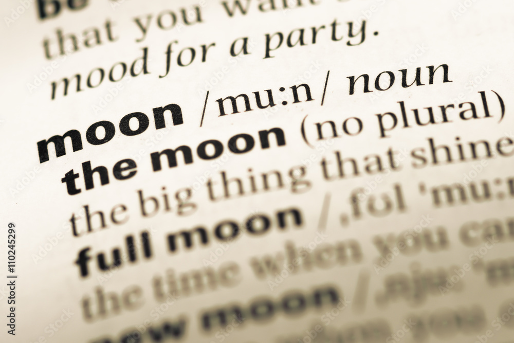 Close up of old English dictionary page with word moon Close up of old English dictionary page with word moon