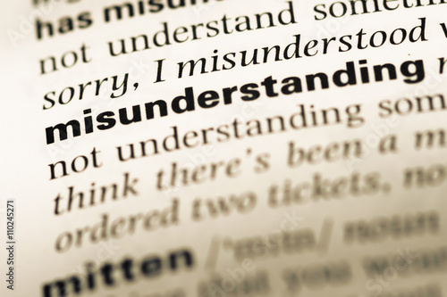 фотографія Close up of old English dictionary page with word misunderstandi