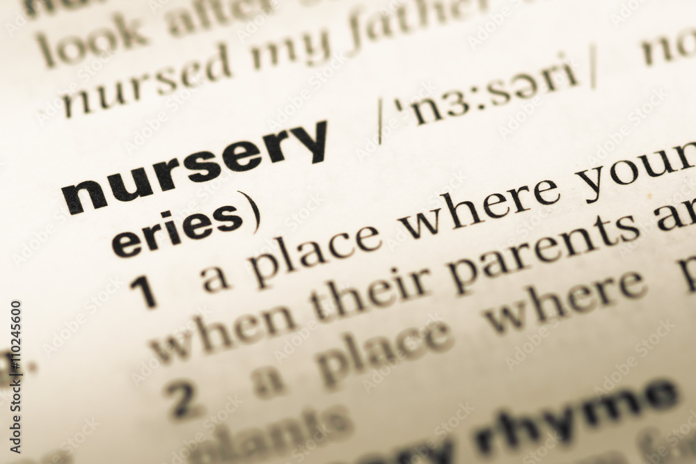 Close up of old English dictionary page with word nursery Close up of old English dictionary page with word nursery