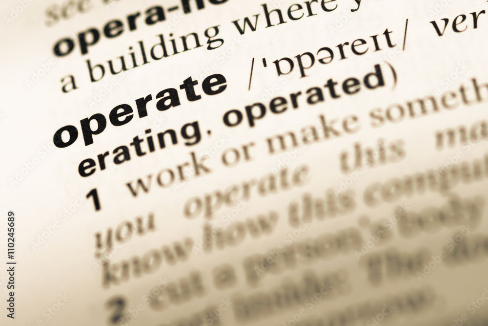 Close up of old English dictionary page with word operate Close up of old English dictionary page with word operate
