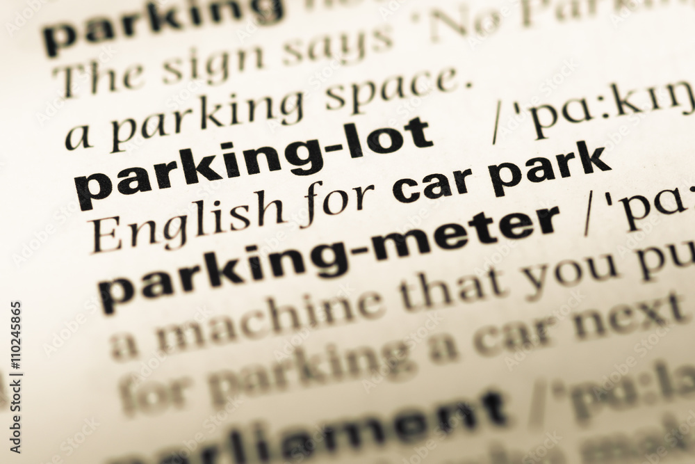 Close up of old English dictionary page with word parking lot Close up of old English dictionary page with word parking lot