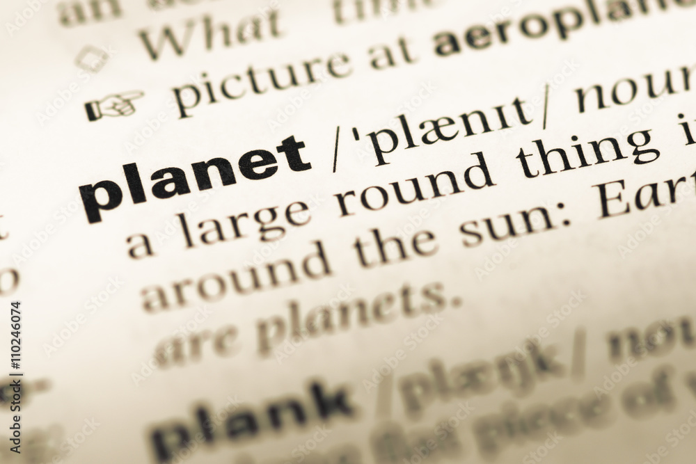 Close up of old English dictionary page with word planet Close up of old English dictionary page with word planet