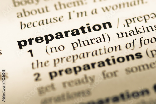 Fototapeta Close up of old English dictionary page with word preparation