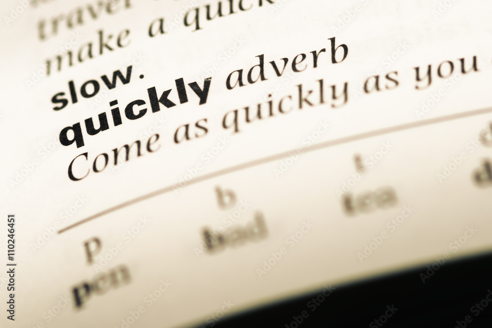 Close up of old English dictionary page with word quickly Close up of old English dictionary page with word quickly
