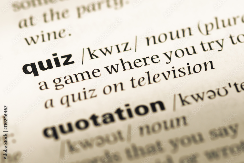 Close up of old English dictionary page with word quiz Close up of old English dictionary page with word quiz