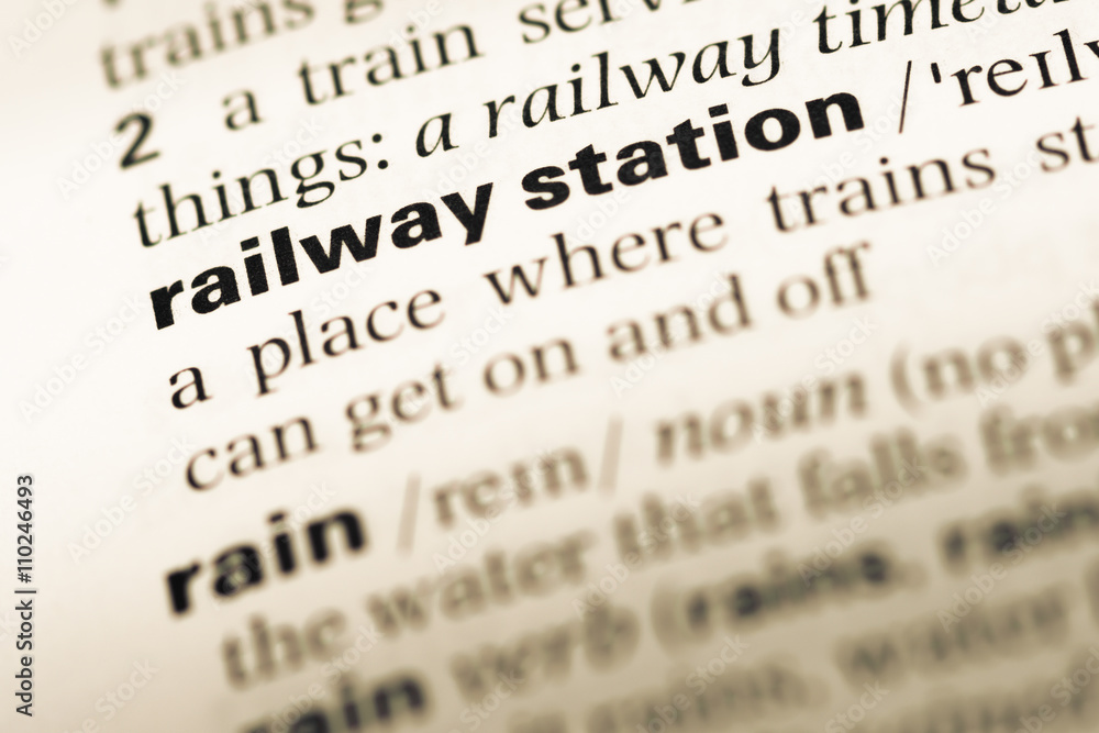 Close up of old English dictionary page with word railway statio Close up of old English dictionary page with word railway statio