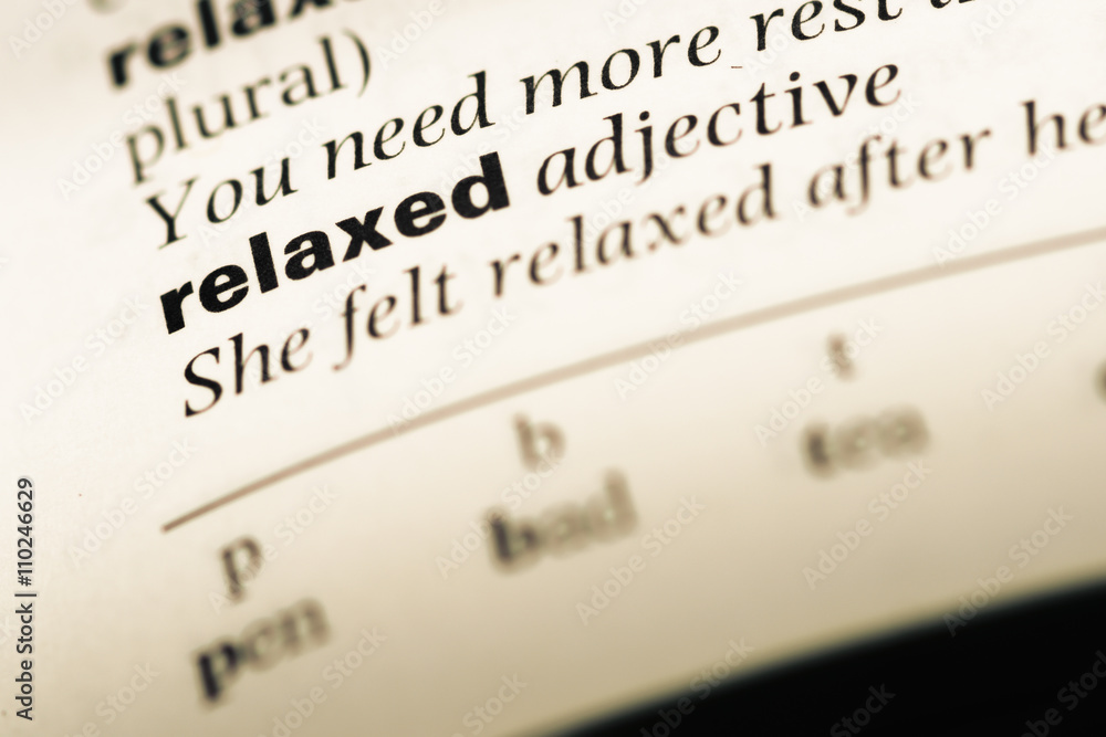 Close up of old English dictionary page with word relaxed Close up of old English dictionary page with word relaxed
