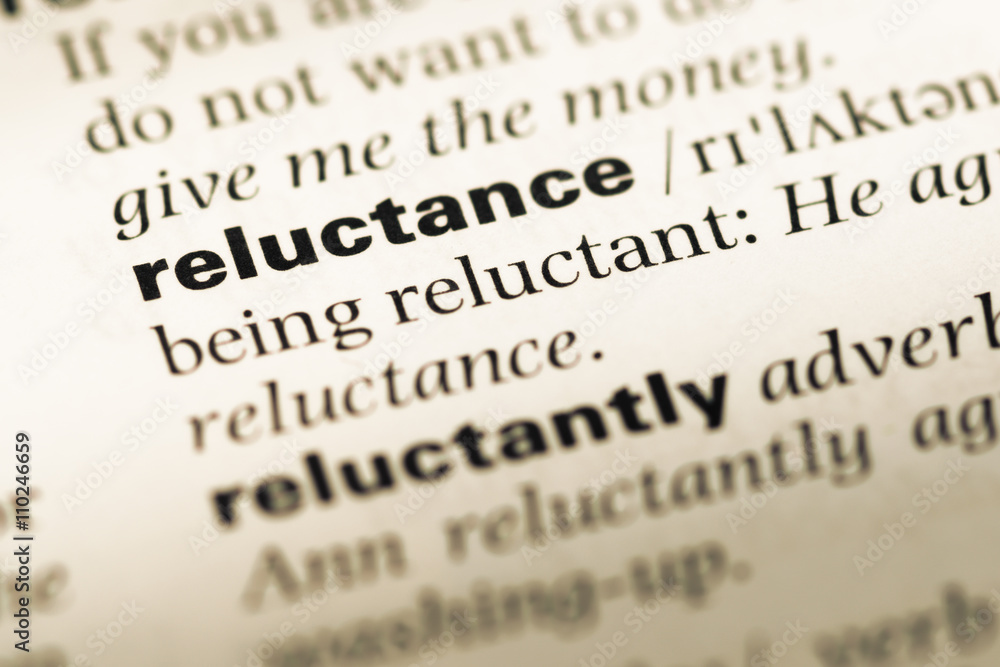 Close up of old English dictionary page with word reluctance Close up of old English dictionary page with word reluctance