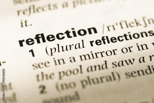 Close up of old English dictionary page with word reflection