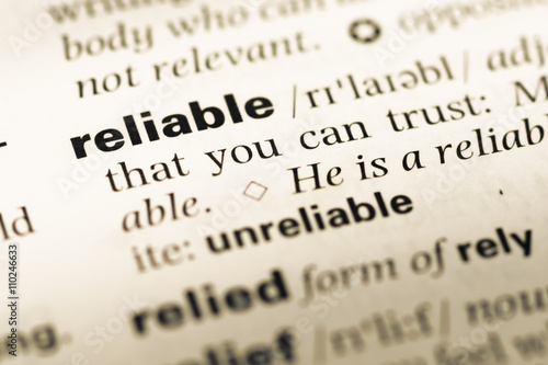 Close up of old English dictionary page with word reliable