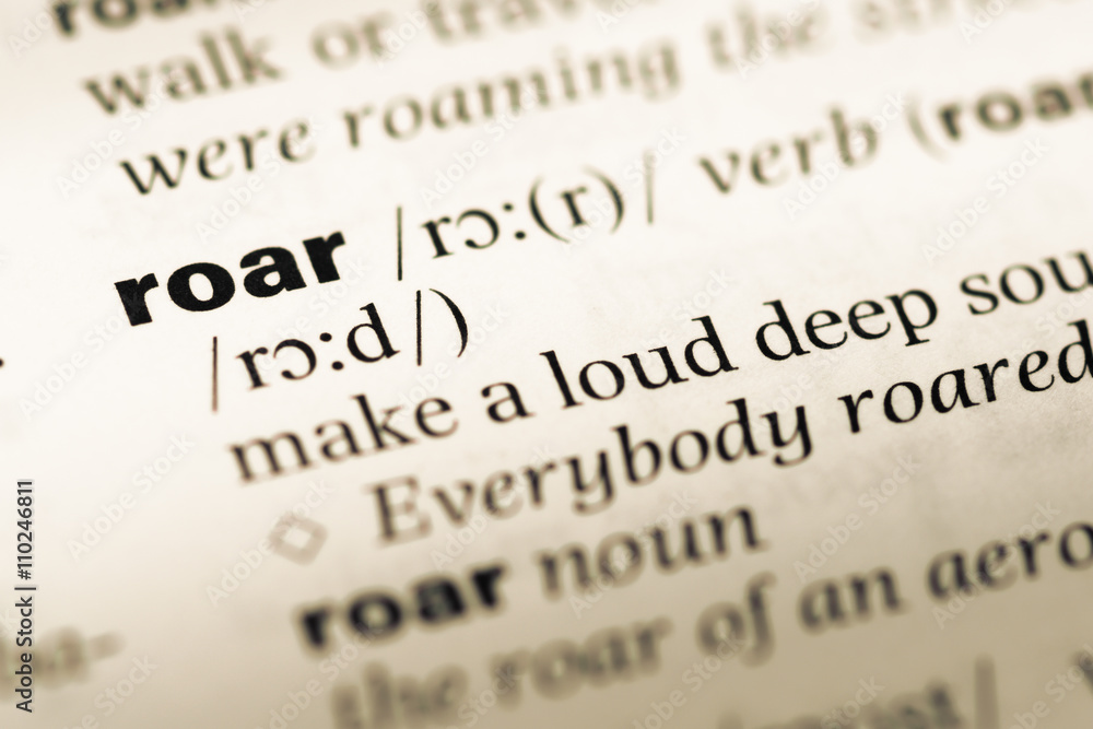Close up of old English dictionary page with word roar Close up of old English dictionary page with word roar