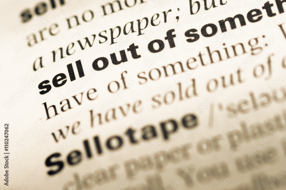 Close up of old English dictionary page with word sell out of Close up of old English dictionary page with word sell out of