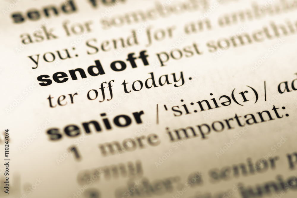 Close up of old English dictionary page with word send off Close up of old English dictionary page with word send off