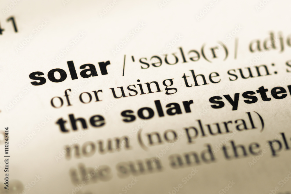 Close up of old English dictionary page with word solar