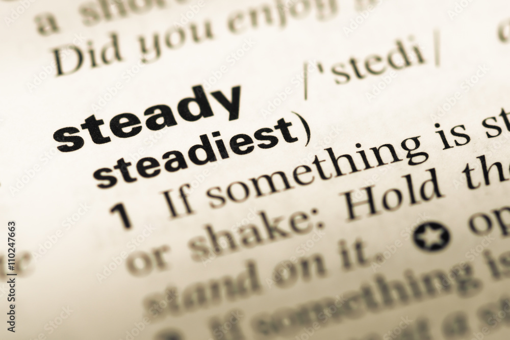 Close up of old English dictionary page with word steady Close up of old English dictionary page with word steady