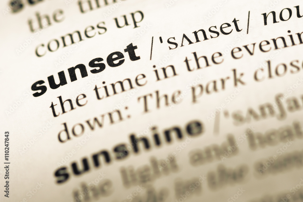 Close up of old English dictionary page with word sunset Close up of old English dictionary page with word sunset