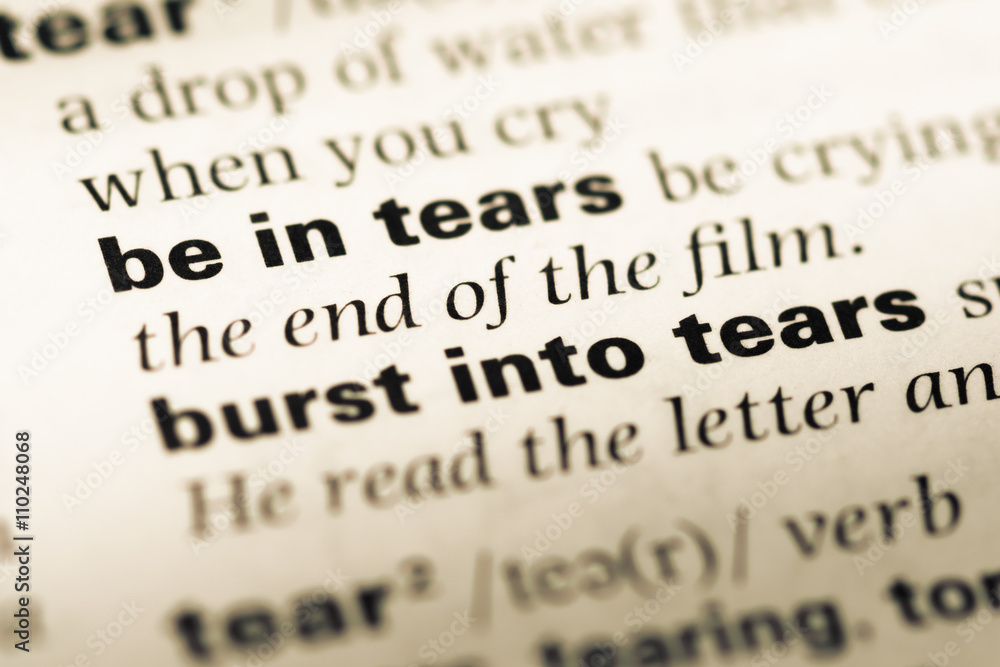 Close up of old English dictionary page with word in tears