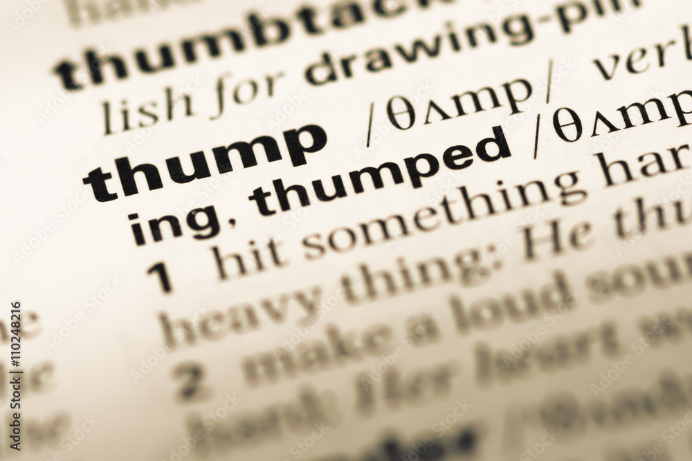 Close up of old English dictionary page with word thump Close up of old English dictionary page with word thump