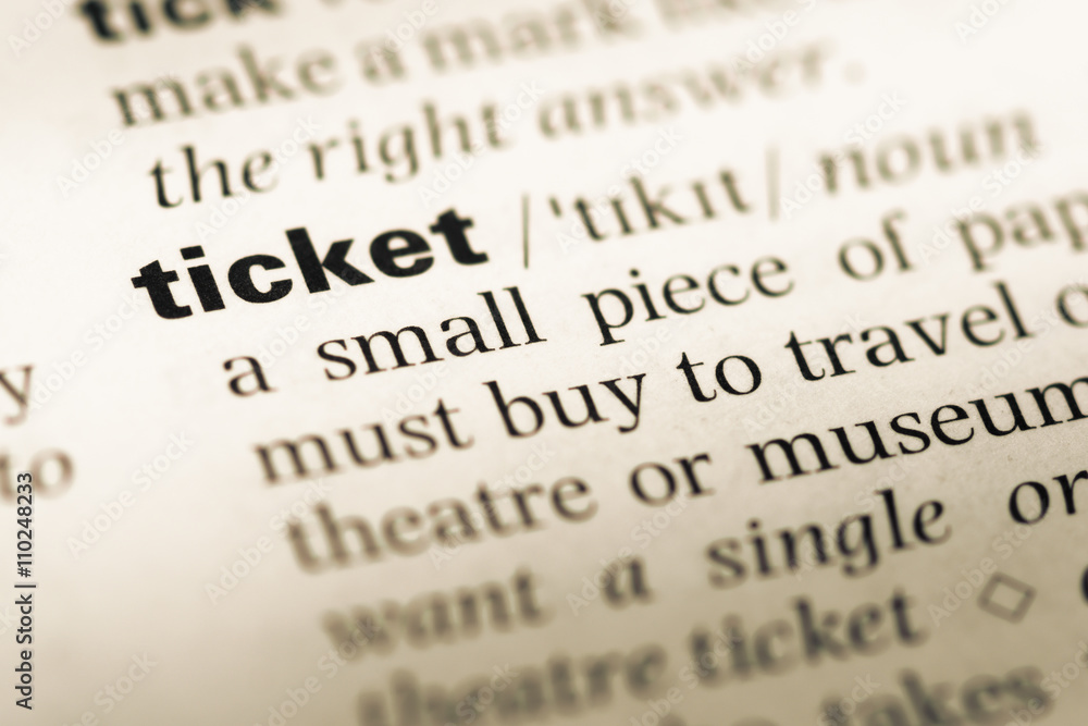 Close up of old English dictionary page with word ticket Close up of old English dictionary page with word ticket