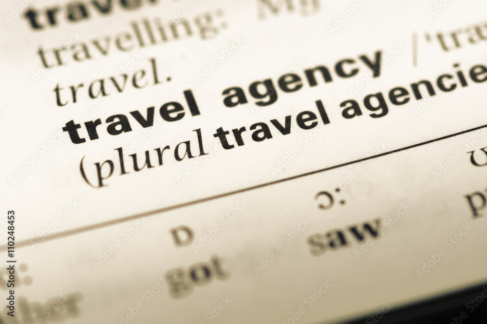 Close up of old English dictionary page with word travel agency Close up of old English dictionary page with word travel agency