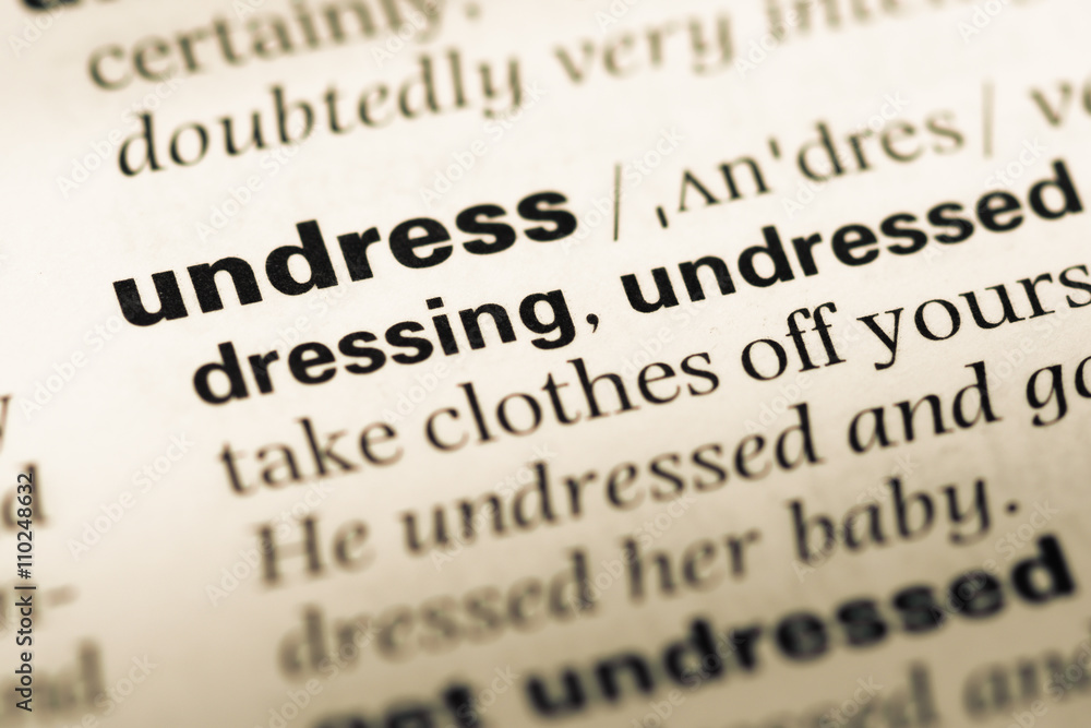 Close up of old English dictionary page with word undress Close up of old English dictionary page with word undress