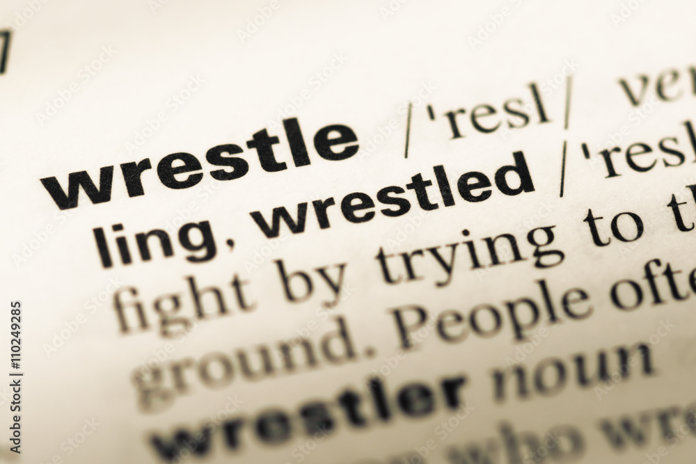 Close up of old English dictionary page with word wrestle Close up of old English dictionary page with word wrestle