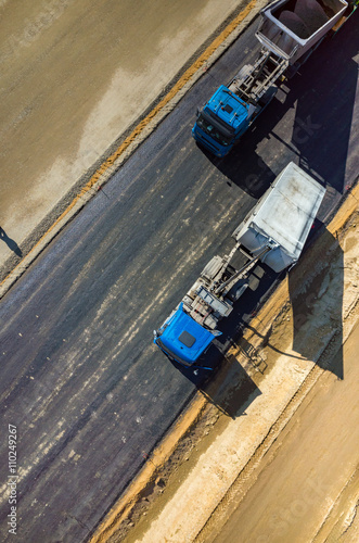 Road rollers working on the construction site aerial view